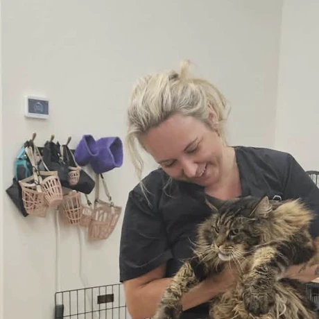 Sabrina, cat groomer at TLC Grooming in Ottawa, holding a long-haired cat